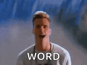 Man In White Shirt With Word Word On Wall GIF