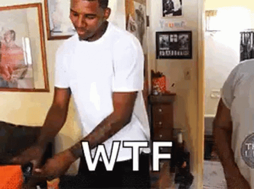Man In White Shirt With WTF On Wall GIF