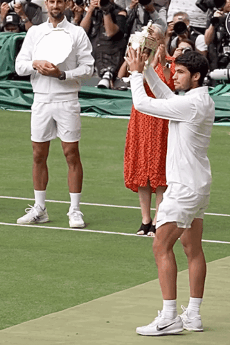Man In White Shorts Holding Trophy GIF