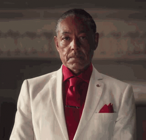 Man in White Suit and Red Tie