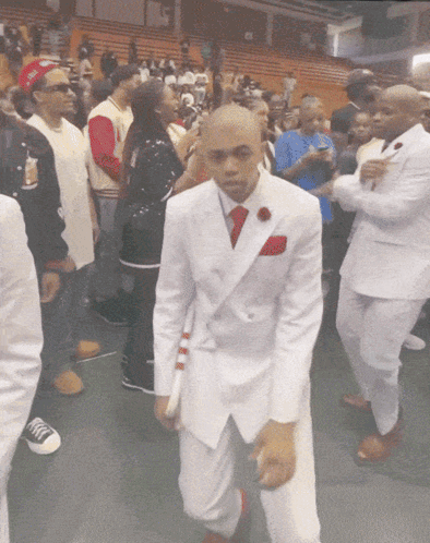Man in White Suit and Red Tie Dancing