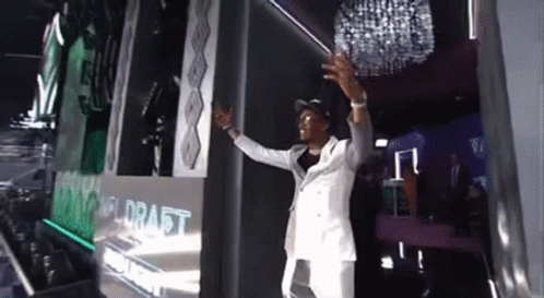 Man in White Suit at Draft Wall