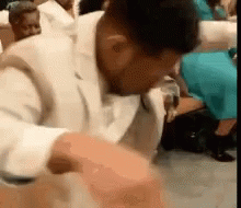 Man in White Suit Dancing in Church