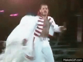 Man in White Suit Dancing on Stage
