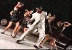 Man in White Suit Dancing With Women