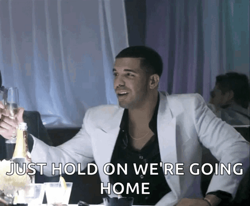 Man in White Suit Holding Champagne Bottle Says Just Hold On We Are Going Home