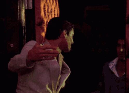 Man in White Suit Holding Gun
