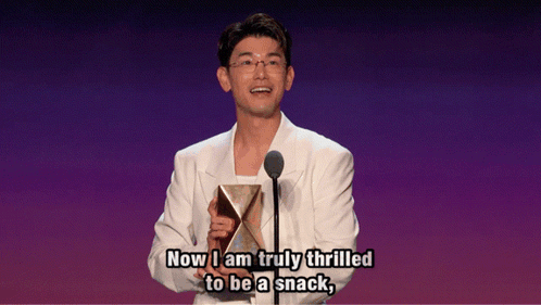 Man In White Suit Holding Trophy Says Now I Am Truly Thrilled To Be A Snack GIF