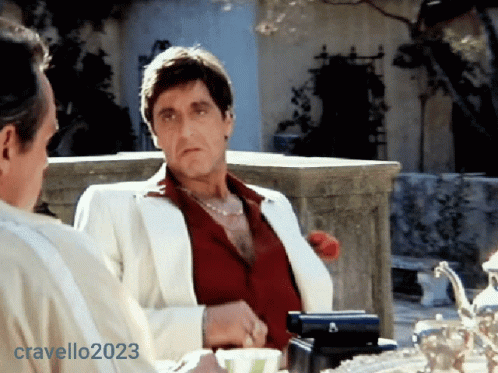 Man in White Suit Next to Man in Red Shirt