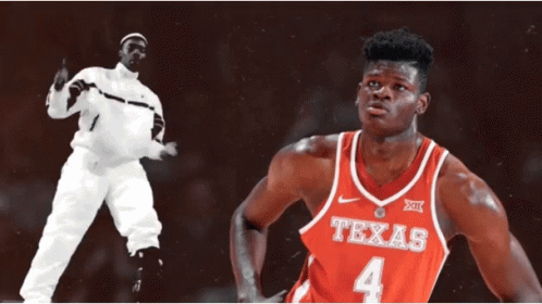 Man in White Suit Next to Man in Texas Jersey