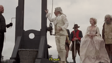 Man In White Suit Says I'll Wait At Guillotine GIF