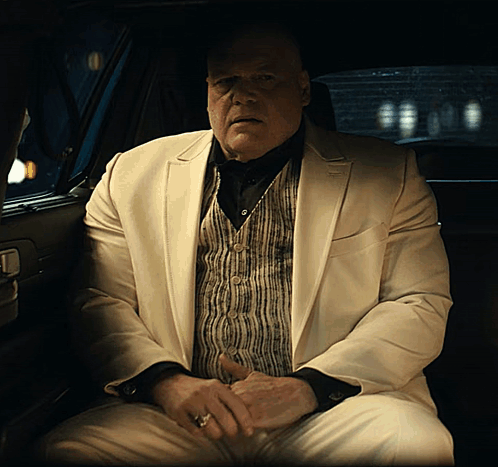 Man in White Suit Sitting in Car