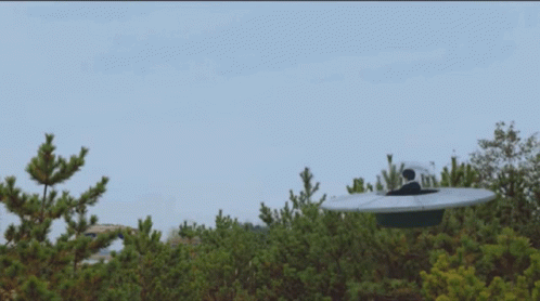 Man In White Suit Sitting On Roof Next To Woman With Pink Hair GIF