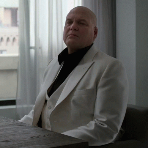 Man in White Suit with Eyes Closed
