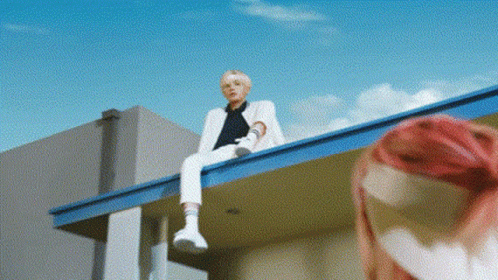 Man In White Suit With Pink-Haired Woman On Roof GIF