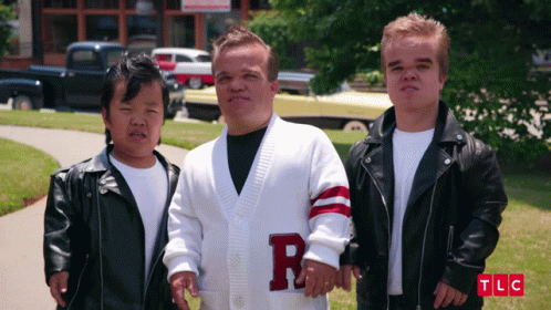 Man In White Sweater With Letter R On Sleeve GIF