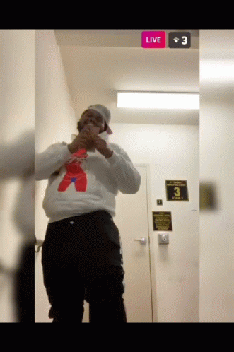 Man in White Sweatshirt and Red Bear at Door with Live Button