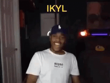 Man in White T-Shirt and Blue Hat Smiling Dancing