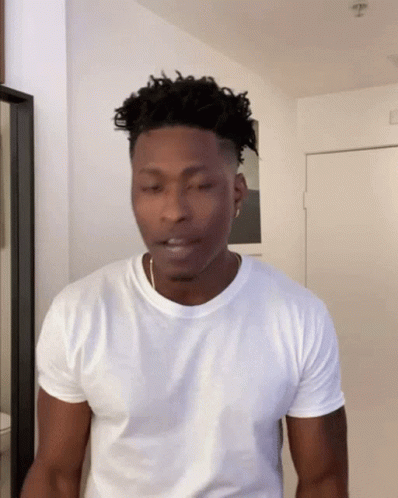 Man in White T-Shirt at Door