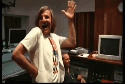 Man in White T-Shirt Laughing and Waving