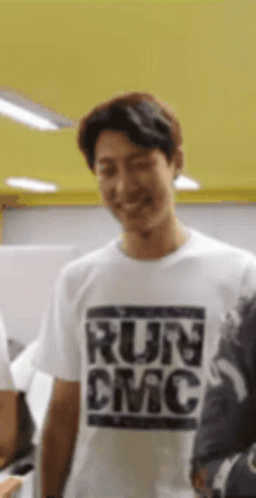 Man in White T-Shirt Saying Run DMC Smiling