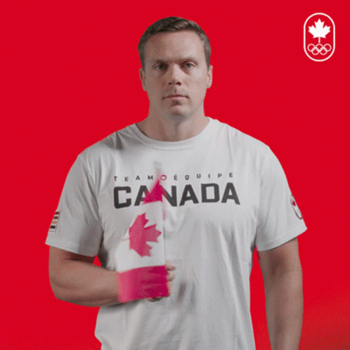 Man in White T-Shirt With Word Canada Holding Flag