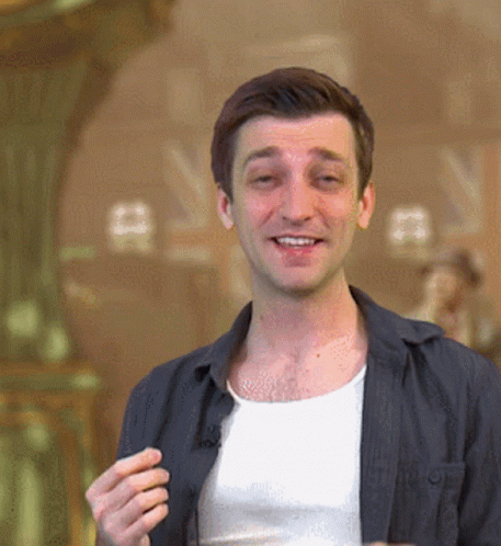 Man In White Tank Top And Black Jacket Smiling GIF