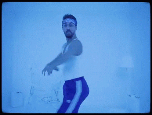 Man in White Tank Top and Blue Pants