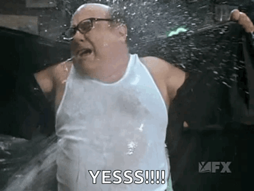 Man in White Tank Top Being Sprayed