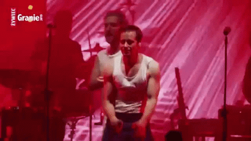 Man In White Tank Top Dancing Against Red Background GIF