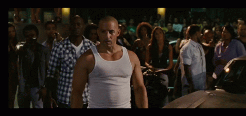 Man in White Tank Top Facing Crowd