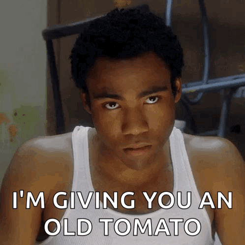 Man in White Tank Top Giving Old Tomato