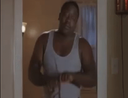 Man In White Tank Top Holding Belt GIF