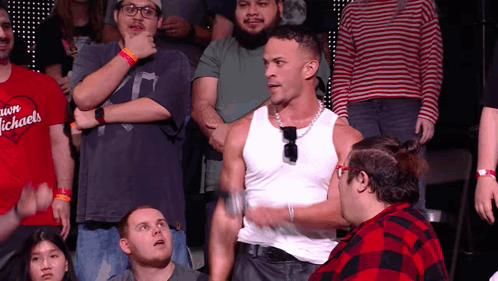 Man In White Tank Top In Front Of Crowd GIF