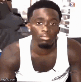 Man in White Tank Top Looking at Camera