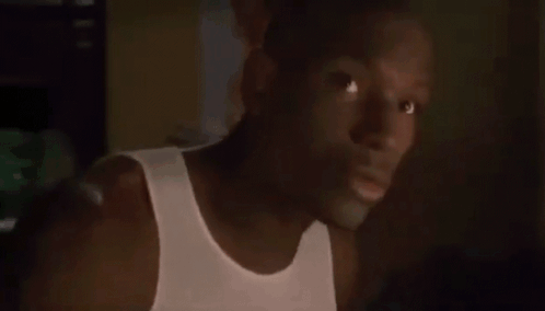 Man in White Tank Top Looking at Camera