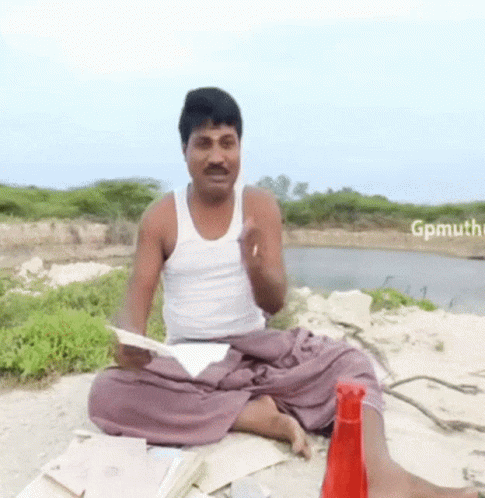 Man in White Tank Top Lotus Position Holding Paper