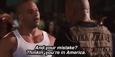 Man In White Tank Top Talking To Another GIF