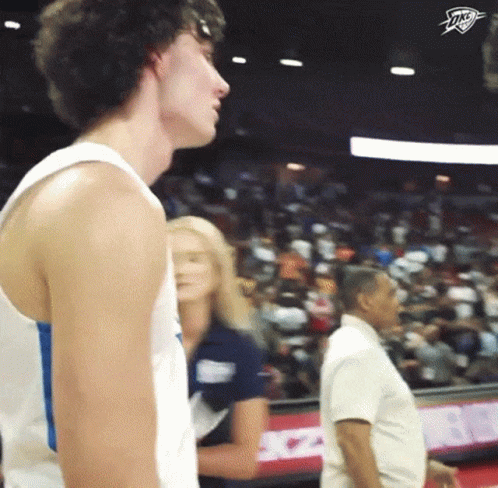 Man in White Tank Top Thunder Logo Crowd