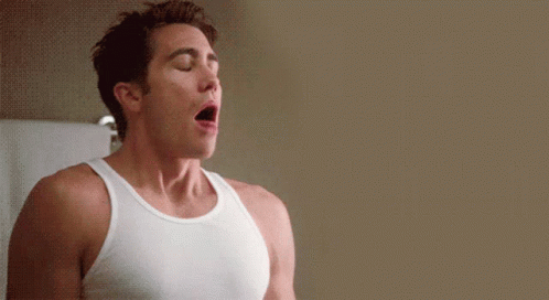 Man in White Tank Top With Eyes Closed