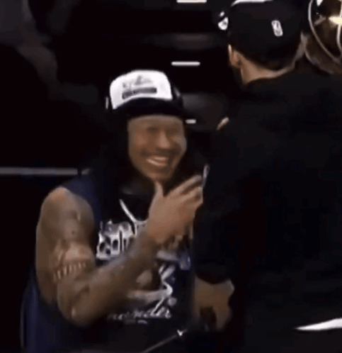 Man in White Tank Top With Thunder Logo Facing Crowd