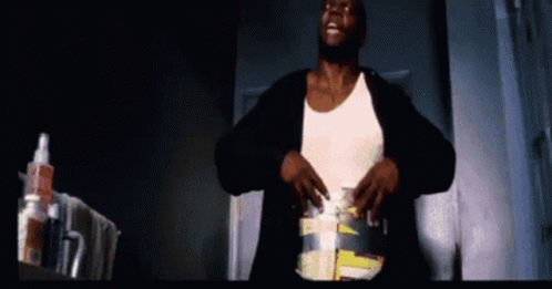 Man In White Tank Top With Toothpaste Bottle In Dark Room GIF