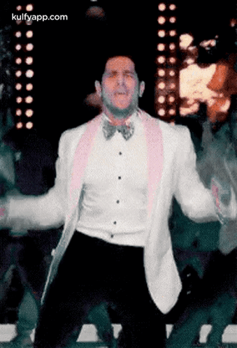 Man In White Tuxedo And Pink Bow Tie Dancing GIF