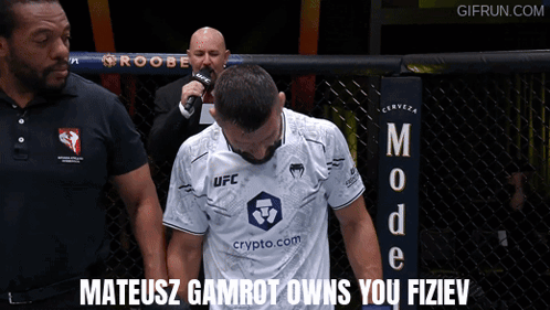 Man in White UFC Shirt with Referee
