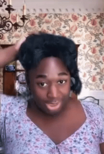 Man in Wig and Floral Shirt Making Funny Face