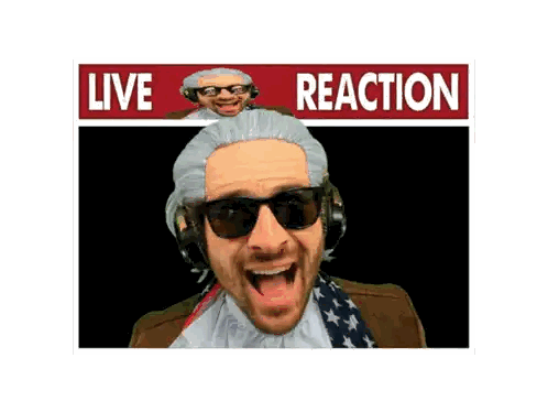 Man in Wig and Sunglasses in Front of Reaction Sign