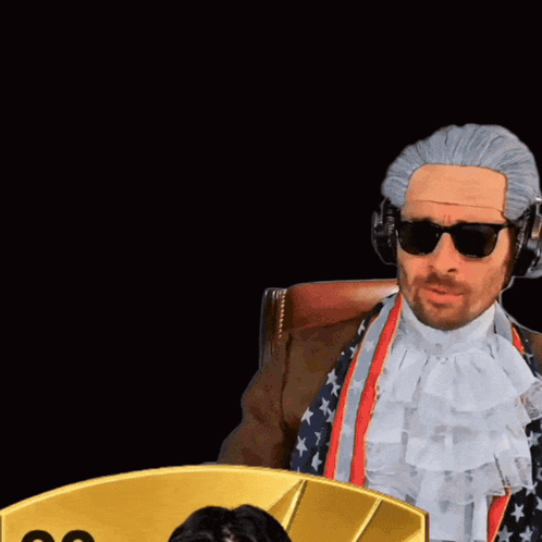 Man in Wig and Sunglasses Next to Card 99