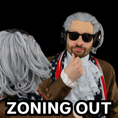 Man in Wig and Sunglasses Next to Woman Zoning Out