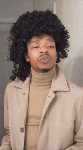 Man In Wig And Tan Trench Coat GIF