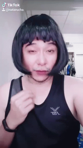 Man In Wig And Telf Tank Top Making Funny Face GIF